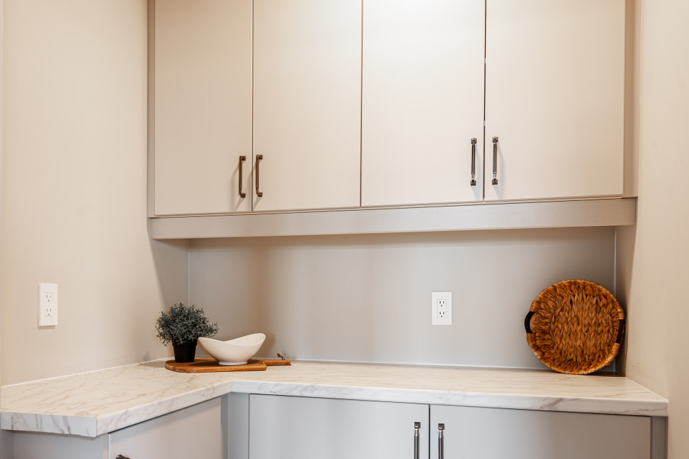 Inspiration for a small transitional galley laminate floor and brown floor open concept kitchen remodel in Toronto with a double-bowl sink, recessed-panel cabinets, beige cabinets, quartz countertops, beige backsplash, porcelain backsplash, stainless steel appliances, an island and white countertops