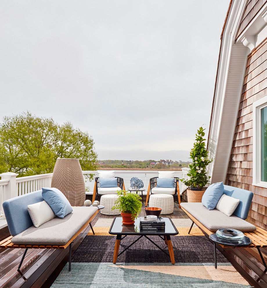 Photo of a beach style deck in New York with no cover.