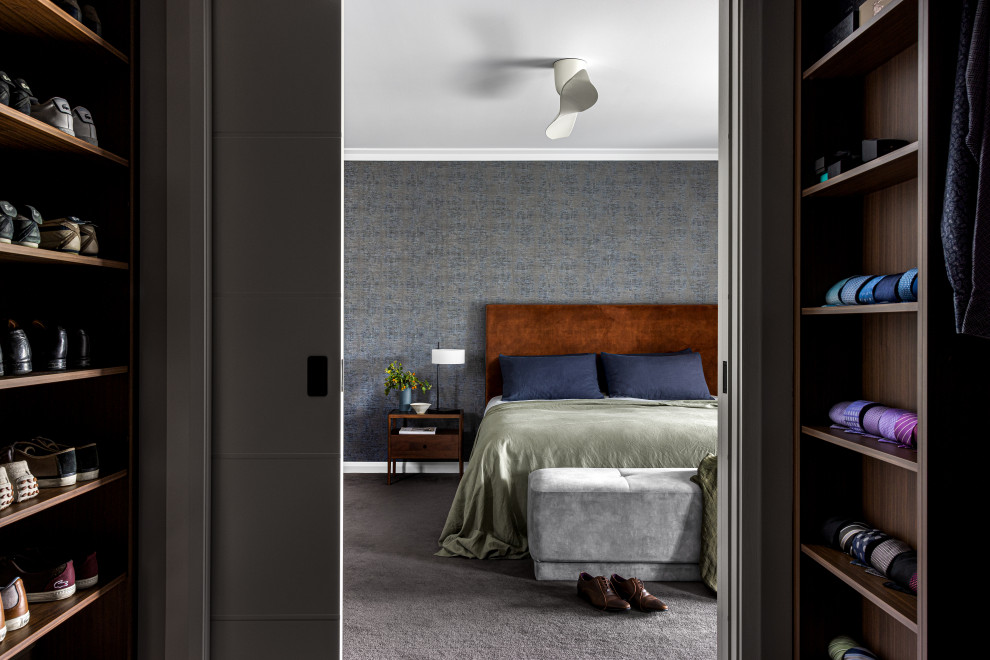 This is an example of a large contemporary master bedroom in Sydney with multi-coloured walls, carpet, no fireplace, brown floors and wallpapered walls.