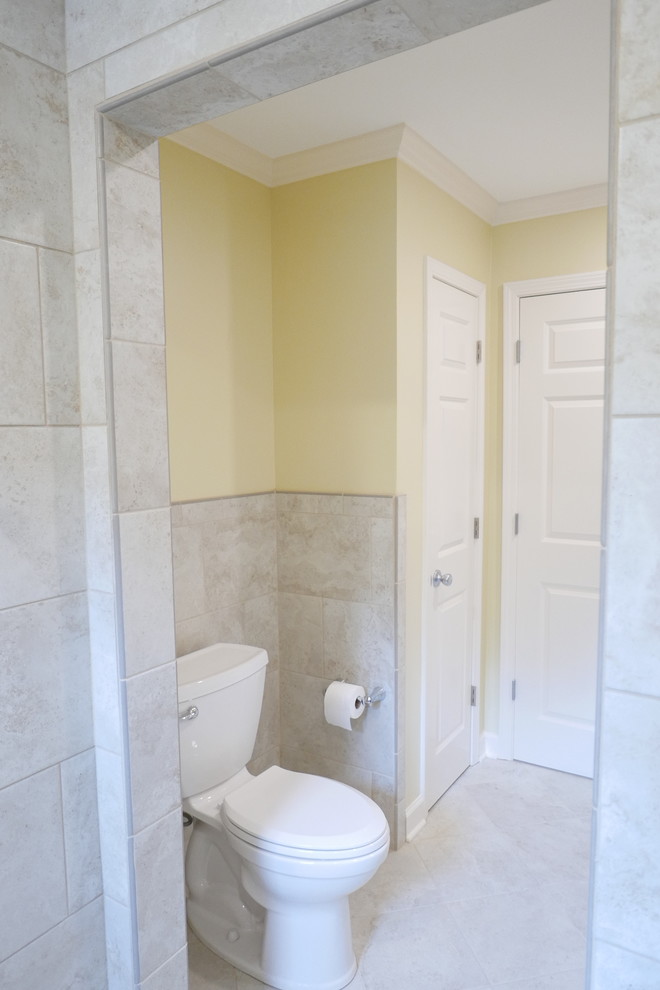 Inspiration for a mid-sized transitional kids bathroom in Other with flat-panel cabinets, white cabinets, a curbless shower, a two-piece toilet, beige tile, porcelain tile, yellow walls, porcelain floors, an undermount sink, engineered quartz benchtops, beige floor, an open shower and multi-coloured benchtops.