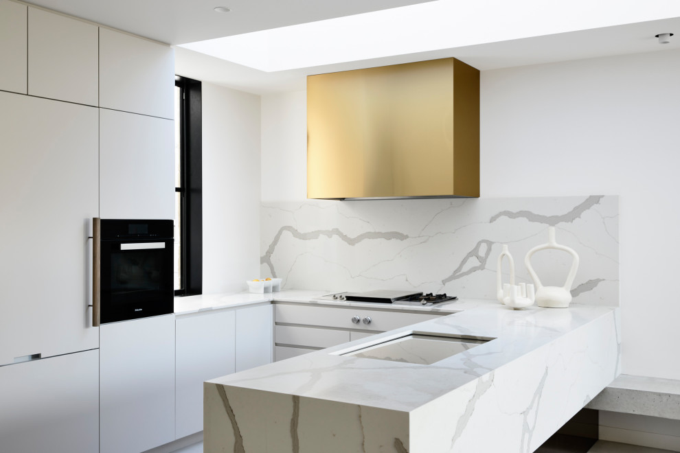 Design ideas for a contemporary u-shaped open plan kitchen in Melbourne with an undermount sink, marble benchtops, white splashback, marble splashback, black appliances, porcelain floors, no island, grey floor and white benchtop.