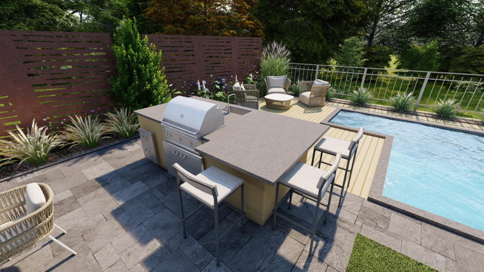 Photo of a large mediterranean front yard patio in Milan with an outdoor kitchen, natural stone pavers and an awning.