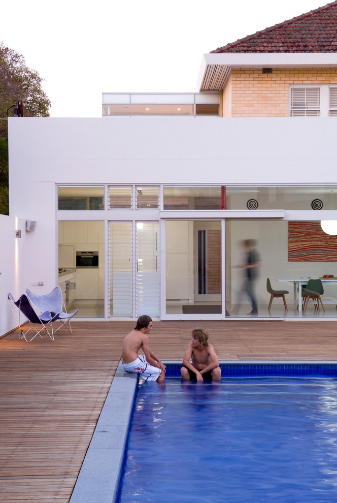 This is an example of a mid-sized contemporary backyard rectangular lap pool in Adelaide with decking.