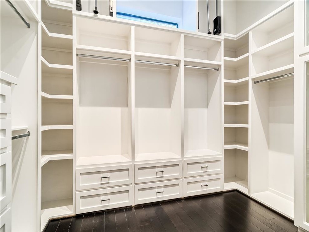 Design ideas for a mid-sized contemporary gender-neutral walk-in wardrobe in Houston with shaker cabinets, white cabinets and dark hardwood floors.