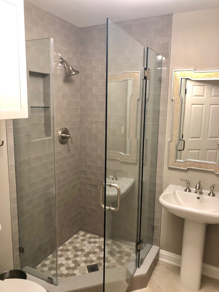 Inspiration for a small transitional 3/4 bathroom in DC Metro with white cabinets, a corner shower, beige tile, subway tile, beige walls, porcelain floors, a pedestal sink, multi-coloured floor, a hinged shower door, a niche, a single vanity and a freestanding vanity.