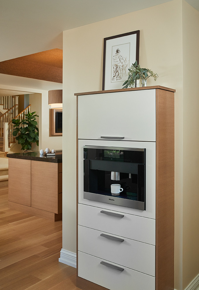 Inspiration for a transitional light wood floor and beige floor home bar remodel with flat-panel cabinets and white cabinets