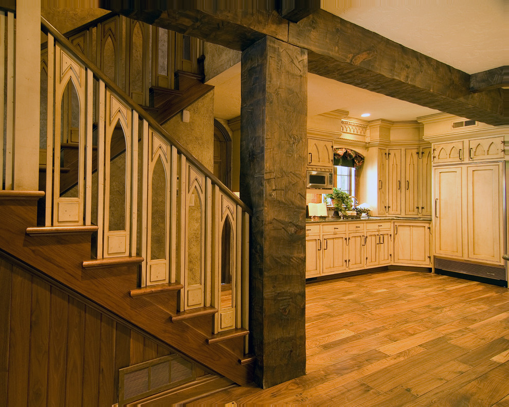This is an example of a mid-sized traditional wood l-shaped staircase in Other with wood risers and wood railing.