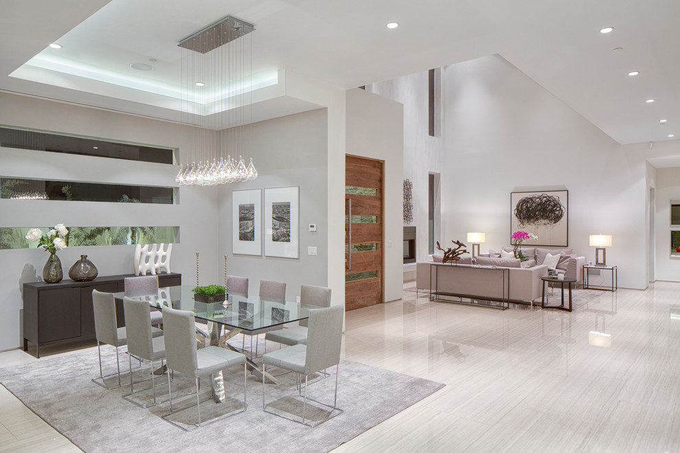 Design ideas for an expansive contemporary open plan dining in Los Angeles with white walls and light hardwood floors.