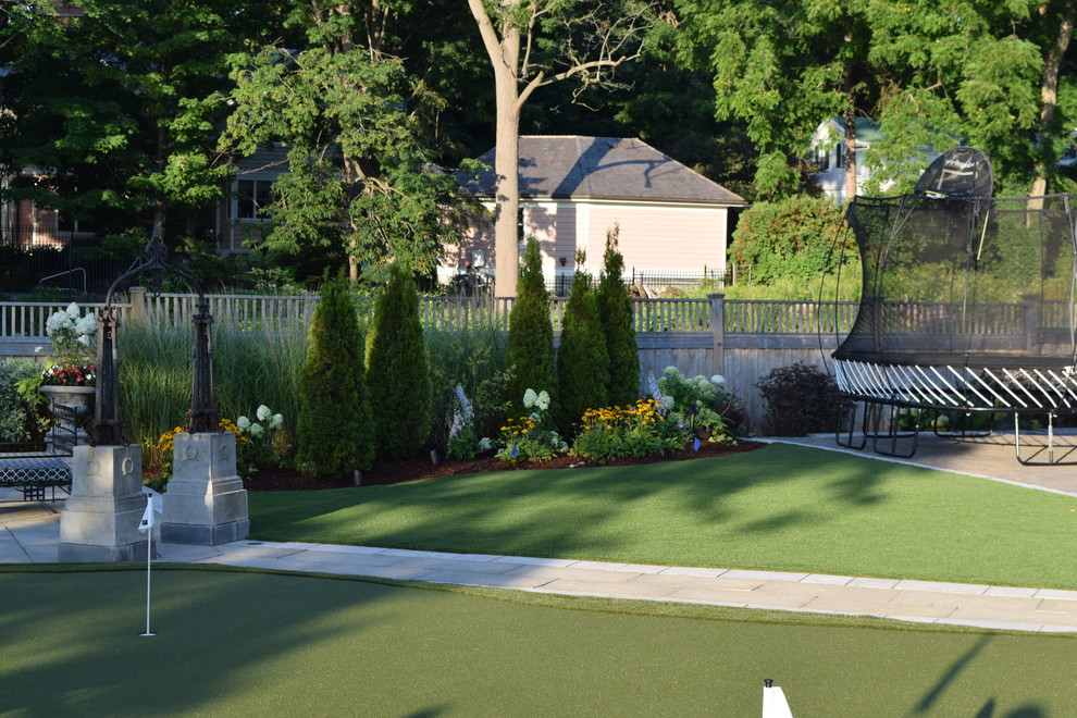 Large traditional backyard partial sun outdoor sport court in Toronto with natural stone pavers.