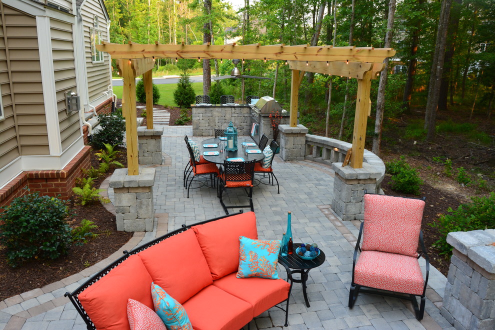 Mid-sized arts and crafts backyard patio in Richmond with a fire feature, concrete pavers and a pergola.