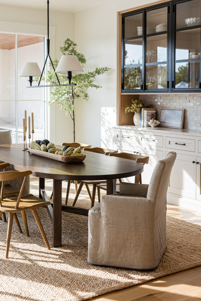Flint Hills - Dining room - transitional light wood floor and beige floor dining room idea in Orange County with white walls
