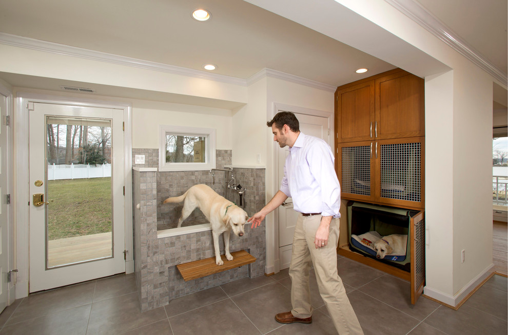 Mid-sized transitional l-shaped porcelain tile utility room photo in DC Metro with a drop-in sink, shaker cabinets, medium tone wood cabinets, quartz countertops, beige walls and a side-by-side washer/dryer
