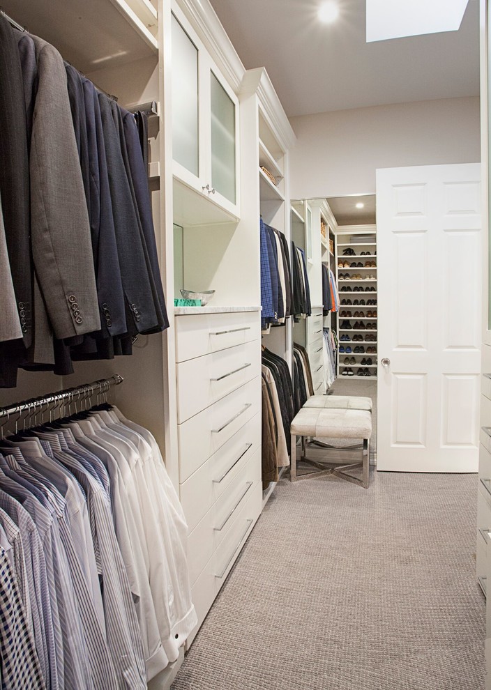 This is an example of a mid-sized transitional men's walk-in wardrobe in Dallas with flat-panel cabinets, white cabinets, carpet and grey floor.
