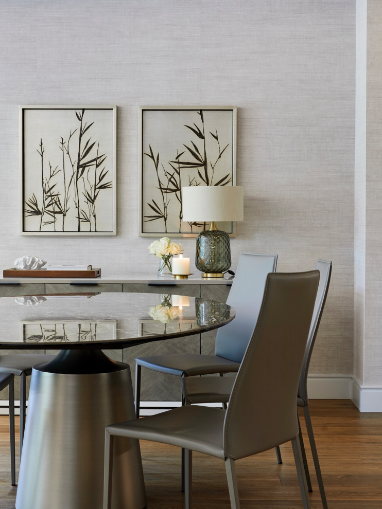 Design ideas for a contemporary dining room in London with feature lighting.