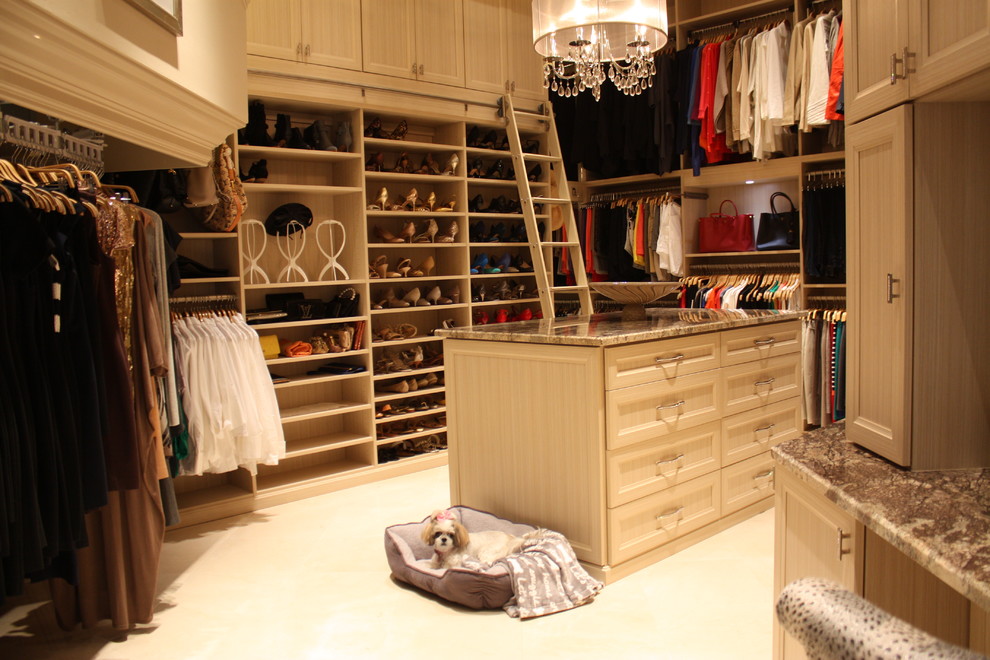 Inspiration for a large traditional gender-neutral walk-in wardrobe in Miami with recessed-panel cabinets and beige cabinets.