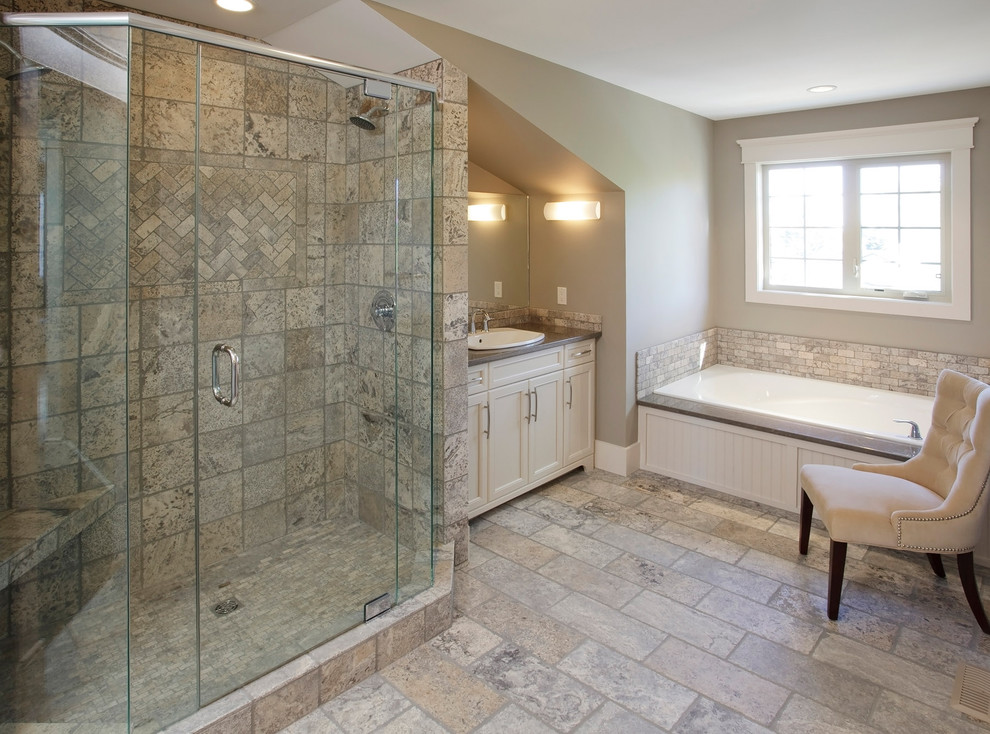 This is an example of a traditional bathroom in Calgary with a drop-in sink, beige cabinets, a drop-in tub, an alcove shower and beige tile.