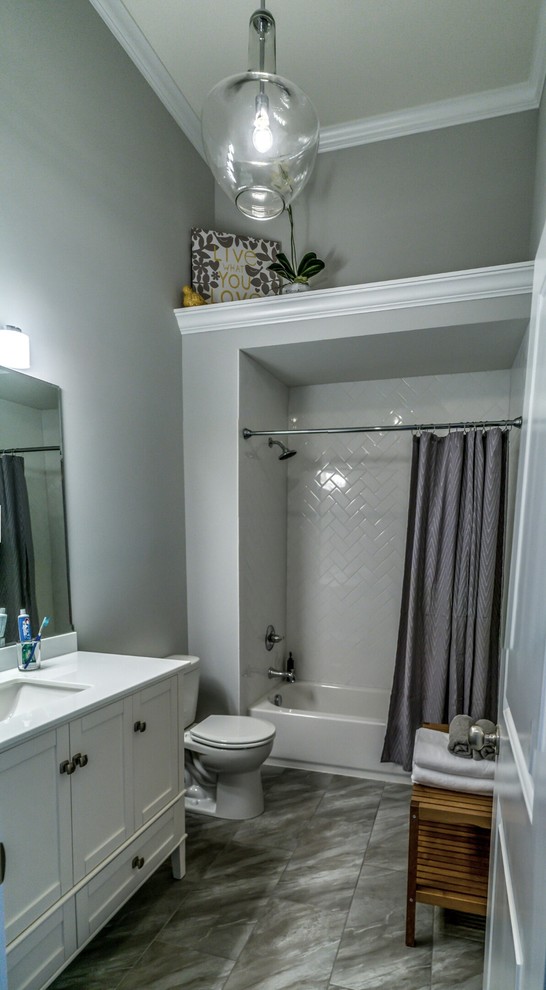 Inspiration for a mid-sized transitional kids' gray tile and ceramic tile ceramic tile alcove bathtub remodel in Chicago with an undermount sink, furniture-like cabinets, white cabinets, quartzite countertops, a two-piece toilet and beige walls