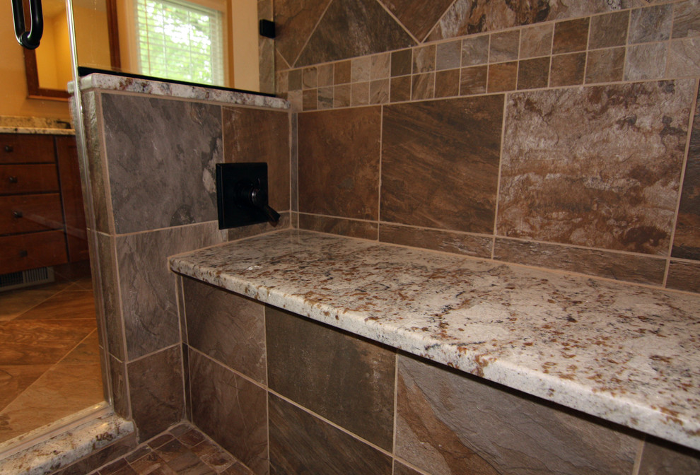 Photo of a large transitional master bathroom in Philadelphia with a wall-mount sink, raised-panel cabinets, dark wood cabinets, quartzite benchtops, a drop-in tub, a two-piece toilet, multi-coloured tile, porcelain tile, beige walls and porcelain floors.