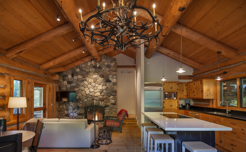 Mid-sized mountain style l-shaped light wood floor eat-in kitchen photo with an undermount sink, light wood cabinets, stainless steel appliances, an island and shaker cabinets