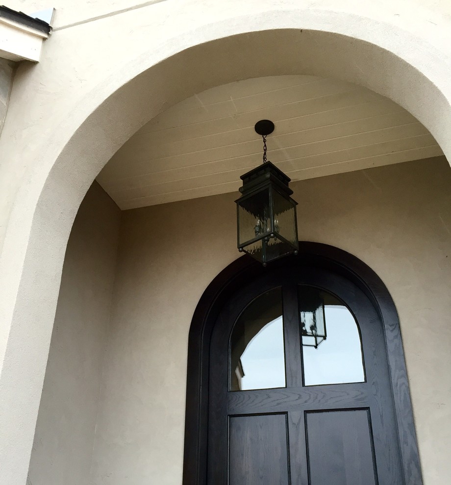 Inspiration for a contemporary two-story stucco gray entryway remodel