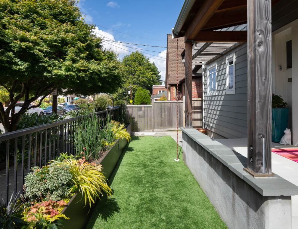 Photo of a medium sized contemporary back partial sun garden for summer in Seattle with a raised bed and concrete paving.