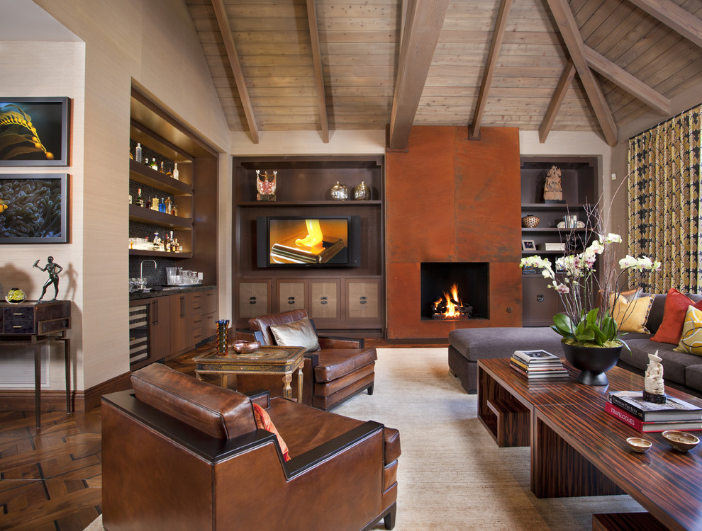 This is an example of a modern living room in San Diego with dark hardwood floors, a standard fireplace, a built-in media wall and a home bar.
