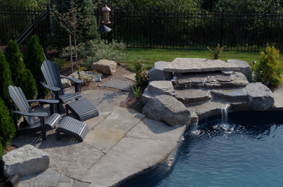 Inspiration for a large traditional backyard full sun garden for summer in Toronto with a water feature and natural stone pavers.