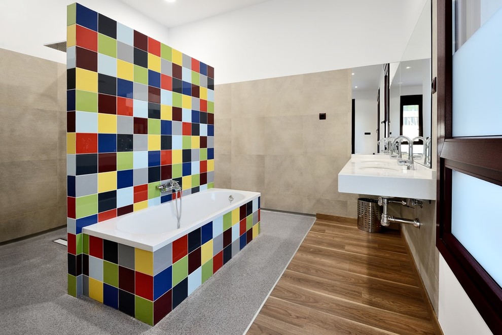Photo of a large contemporary master bathroom in Other with a curbless shower, multi-coloured tile, ceramic tile, a wall-mount sink, marble benchtops, an open shower, white benchtops, a corner tub, white walls, medium hardwood floors and brown floor.