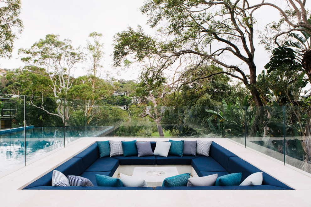 Design ideas for an expansive contemporary backyard deck in Sydney with a fire feature.