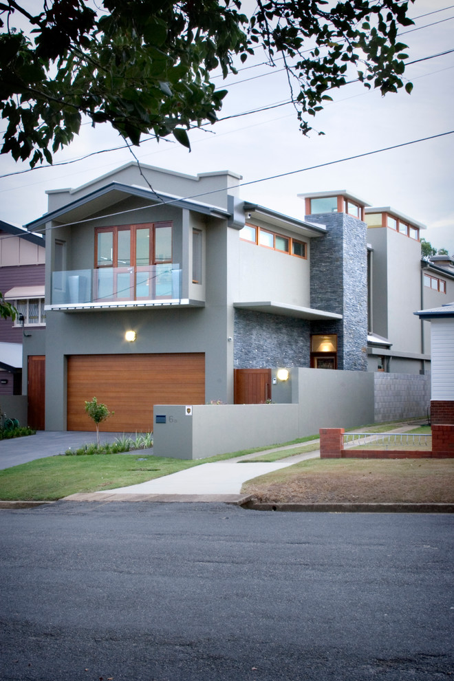This is an example of a contemporary two-storey concrete grey exterior in Brisbane with a gable roof.