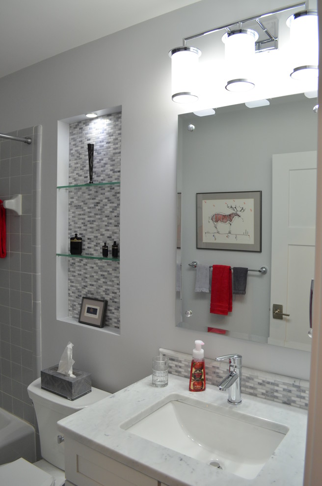 Transitional gray tile bathroom photo with shaker cabinets, white cabinets and marble countertops