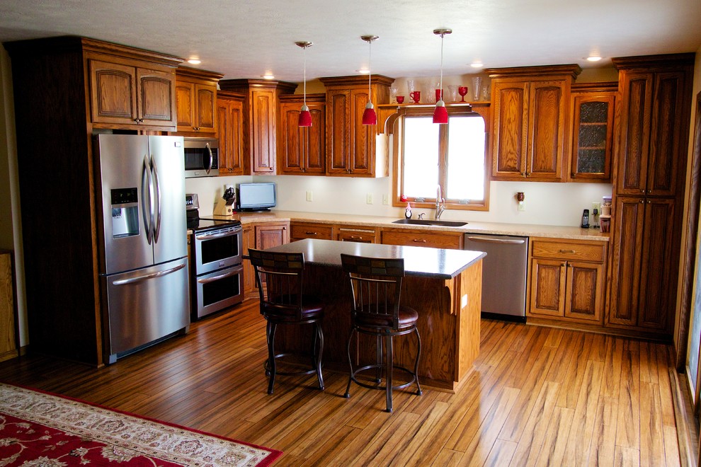 Eat-in kitchen - mid-sized single-wall eat-in kitchen idea with an undermount sink, medium tone wood cabinets, stainless steel appliances, an island and laminate countertops
