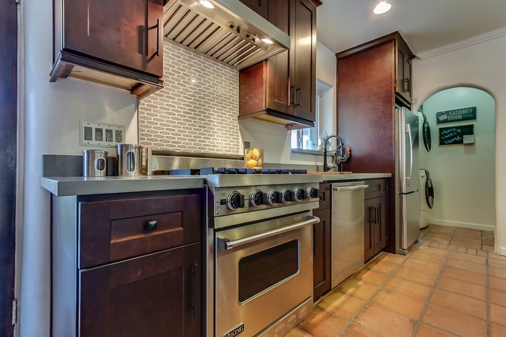 Large transitional galley terra-cotta tile and brown floor open concept kitchen photo in Phoenix with an undermount sink, shaker cabinets, dark wood cabinets, quartz countertops, stainless steel appliances and an island