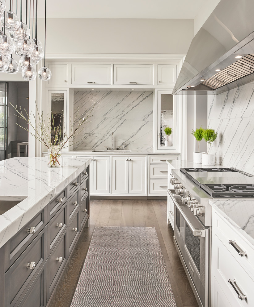 Design ideas for a large transitional eat-in kitchen in Chicago with a single-bowl sink, shaker cabinets, white cabinets, quartzite benchtops, grey splashback, stone slab splashback, stainless steel appliances, dark hardwood floors, with island and grey floor.