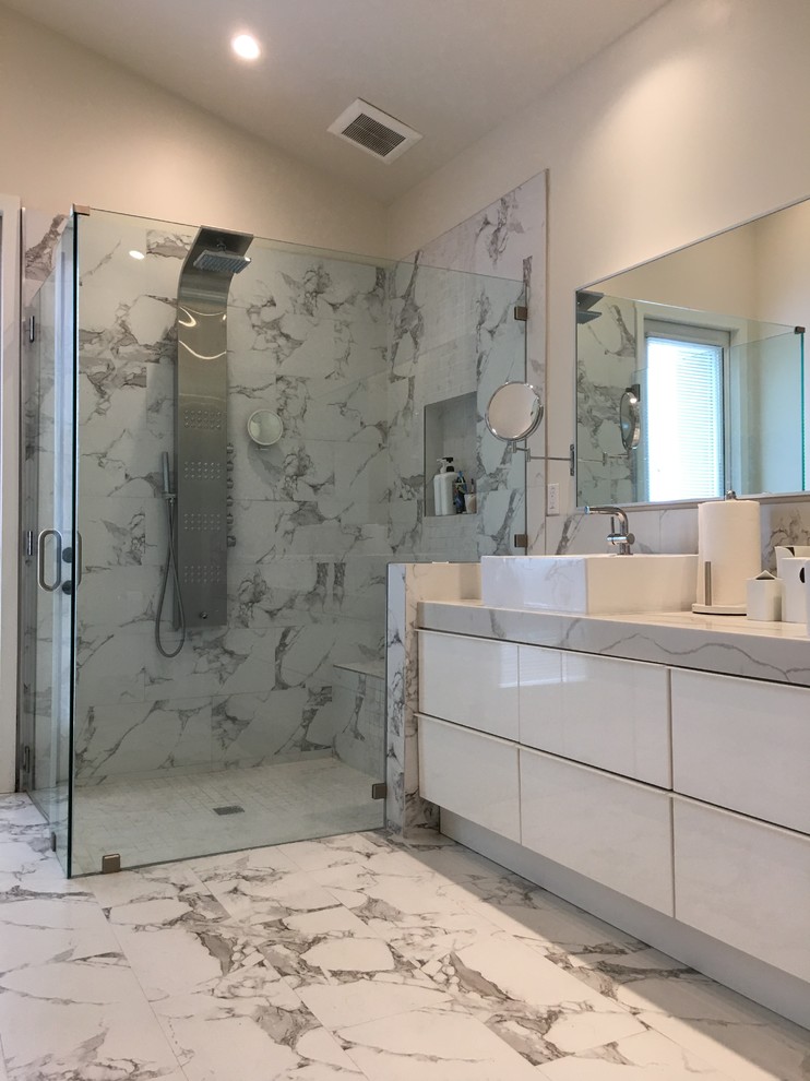Design ideas for a mid-sized contemporary master bathroom in Orange County with flat-panel cabinets, turquoise cabinets, an alcove shower, gray tile, stone tile, white walls, marble floors, a vessel sink, marble benchtops, white floor and a sliding shower screen.
