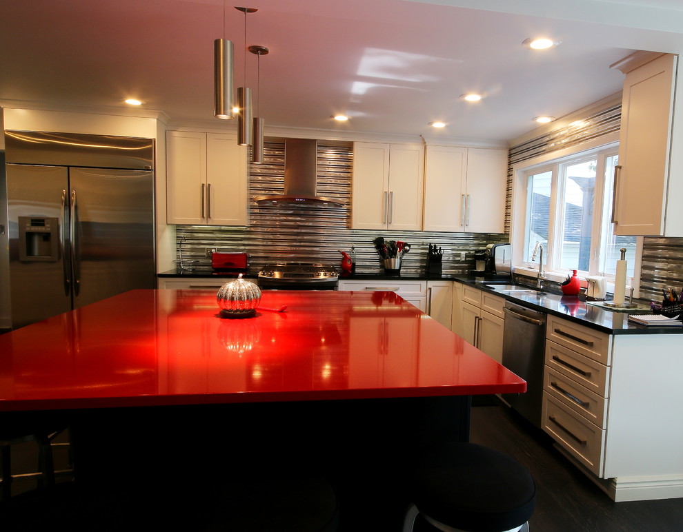 Large eclectic l-shaped dark wood floor eat-in kitchen photo with an undermount sink, flat-panel cabinets, white cabinets, quartz countertops, metallic backsplash, metal backsplash, stainless steel appliances and an island