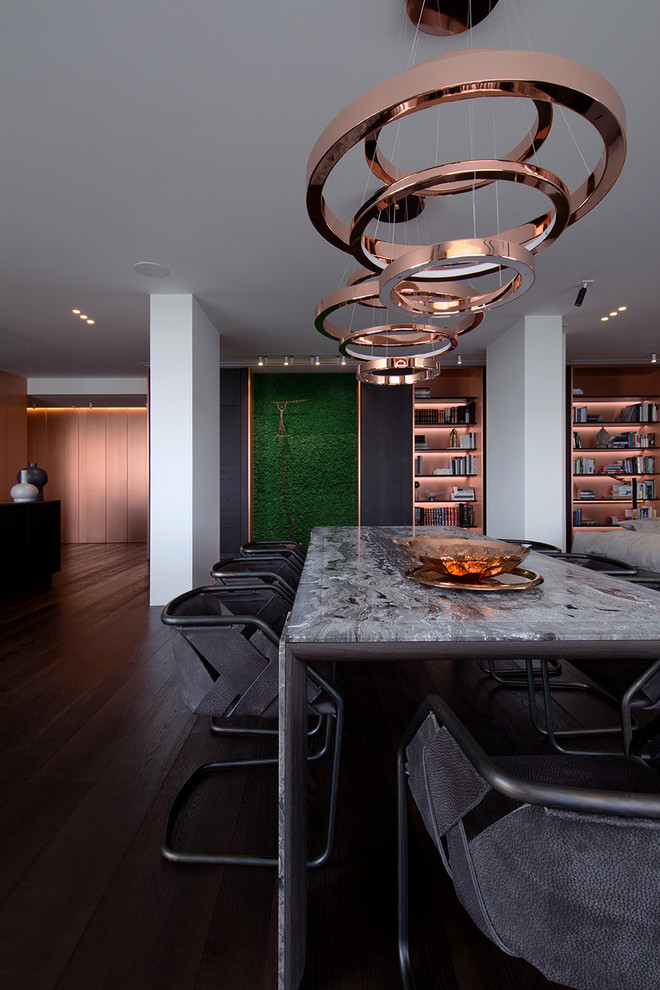 Photo of a contemporary dining room in Miami with white walls, dark hardwood floors and brown floor.