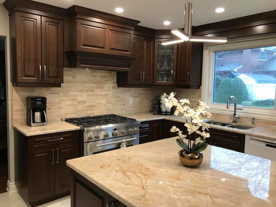 Inspiration for a transitional u-shaped marble floor and beige floor eat-in kitchen remodel with an undermount sink, raised-panel cabinets, beige cabinets, quartzite countertops, beige backsplash, marble backsplash, stainless steel appliances and an island