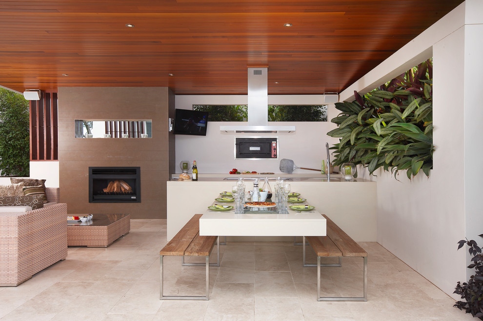 Inspiration for a mid-sized contemporary courtyard patio in Sydney with a roof extension.