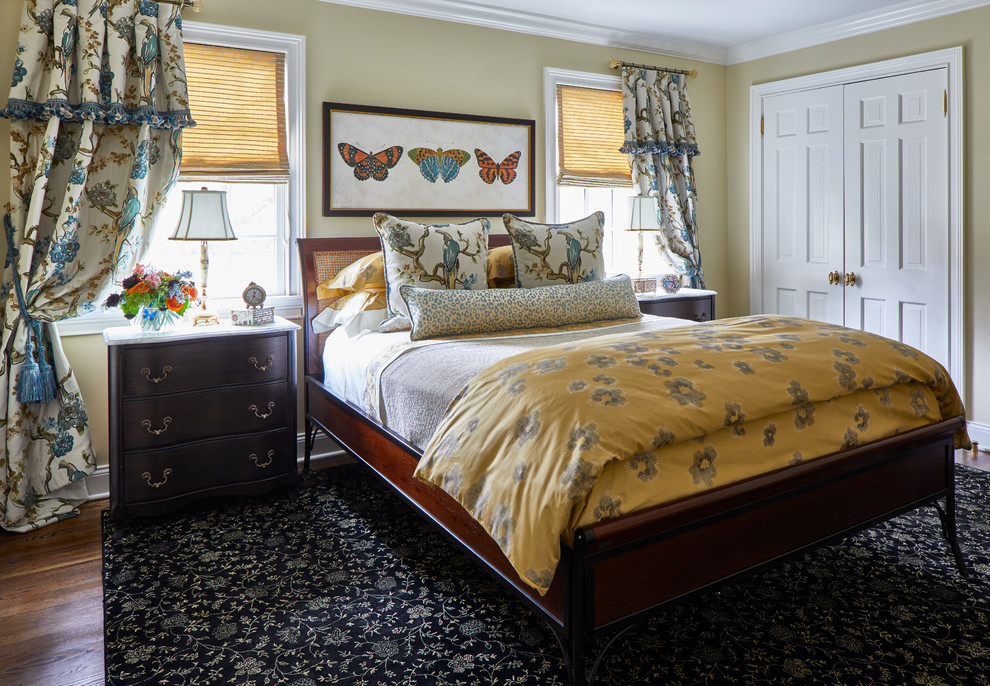 Traditional Rumson Home - This space is intended for the homeowner's daughter for her occasional visits. The space was created to be a happy and welcoming room for her to come back to. Inspiration for the palette was drawn from the  blue and gold bird fabric seen on the drapery and again on the accent pillows. The gold was repeated in the duvet, the roman shades and the patterned area rug.  Feminine patterns and motifs were selected;  florals, butterflies and leopard.