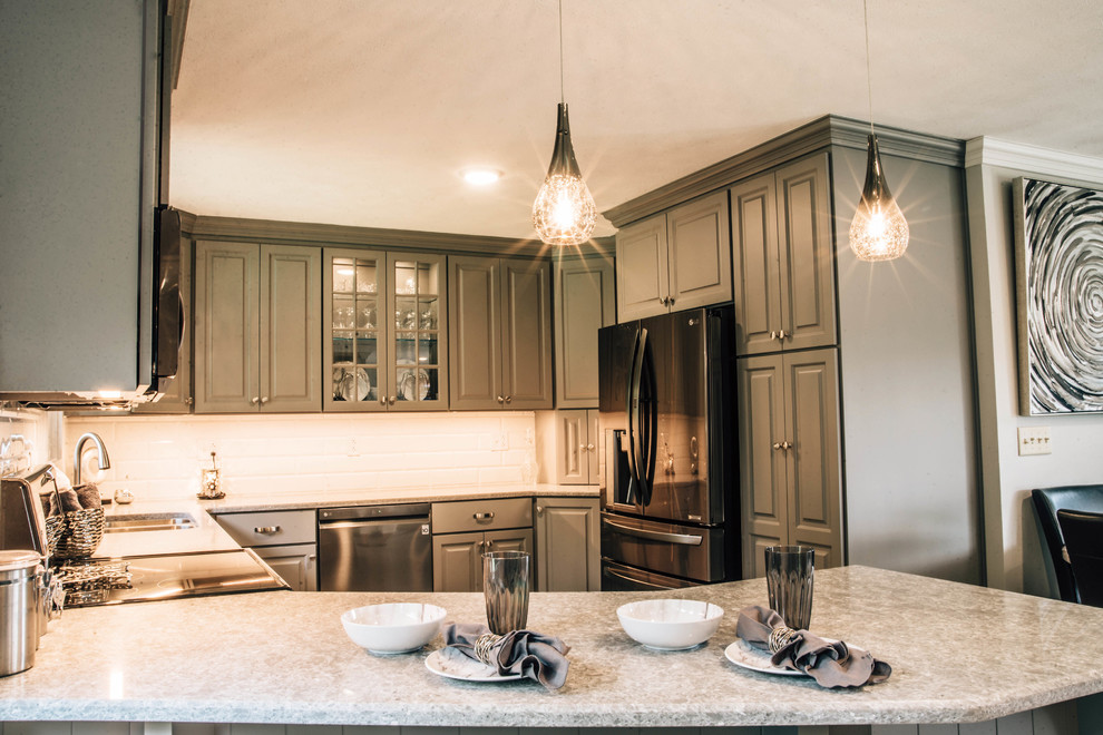 Mid-sized transitional u-shaped medium tone wood floor and brown floor eat-in kitchen photo with a double-bowl sink, raised-panel cabinets, gray cabinets, granite countertops, white backsplash, ceramic backsplash, stainless steel appliances, a peninsula and gray countertops