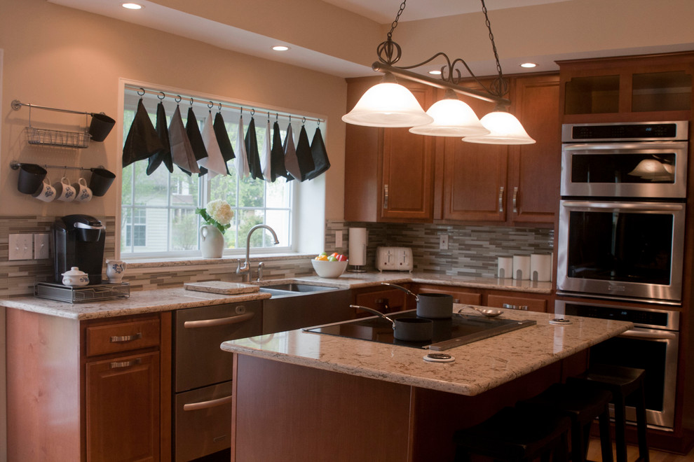 Inspiration for a mid-sized transitional l-shaped medium tone wood floor open concept kitchen remodel in DC Metro with a double-bowl sink, raised-panel cabinets, medium tone wood cabinets, granite countertops, brown backsplash, stainless steel appliances and matchstick tile backsplash