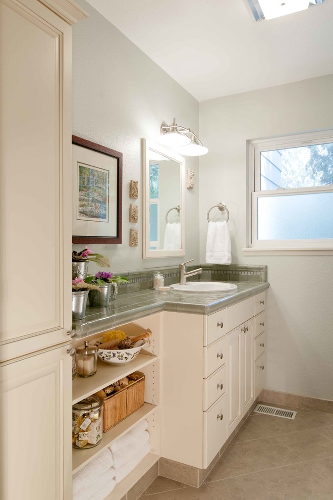 Freestanding bathtub - mid-sized transitional master brown tile and ceramic tile porcelain tile freestanding bathtub idea in Seattle with a vessel sink, recessed-panel cabinets, white cabinets, granite countertops, a two-piece toilet and gray walls