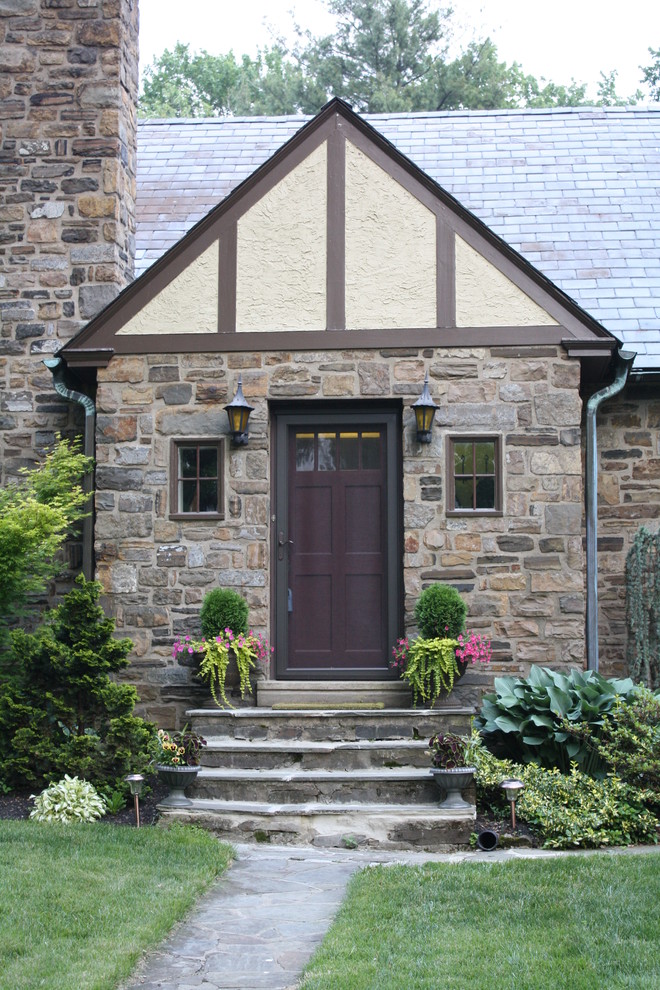 Cette photo montre une façade de maison marron chic en pierre de taille moyenne et à un étage.