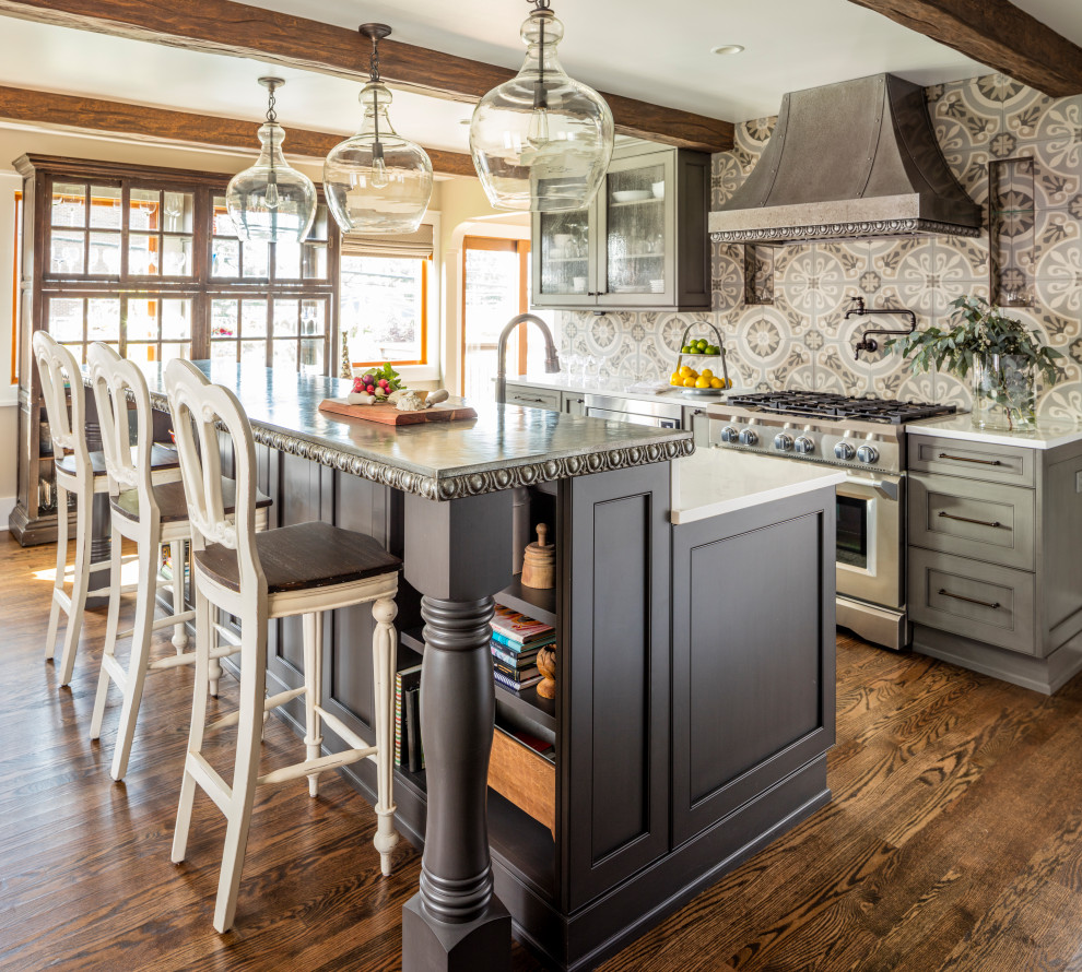 Inspiration for a traditional galley kitchen in Seattle with recessed-panel cabinets, grey cabinets, zinc benchtops, multi-coloured splashback, porcelain splashback, stainless steel appliances, with island, brown floor, grey benchtop and dark hardwood floors.