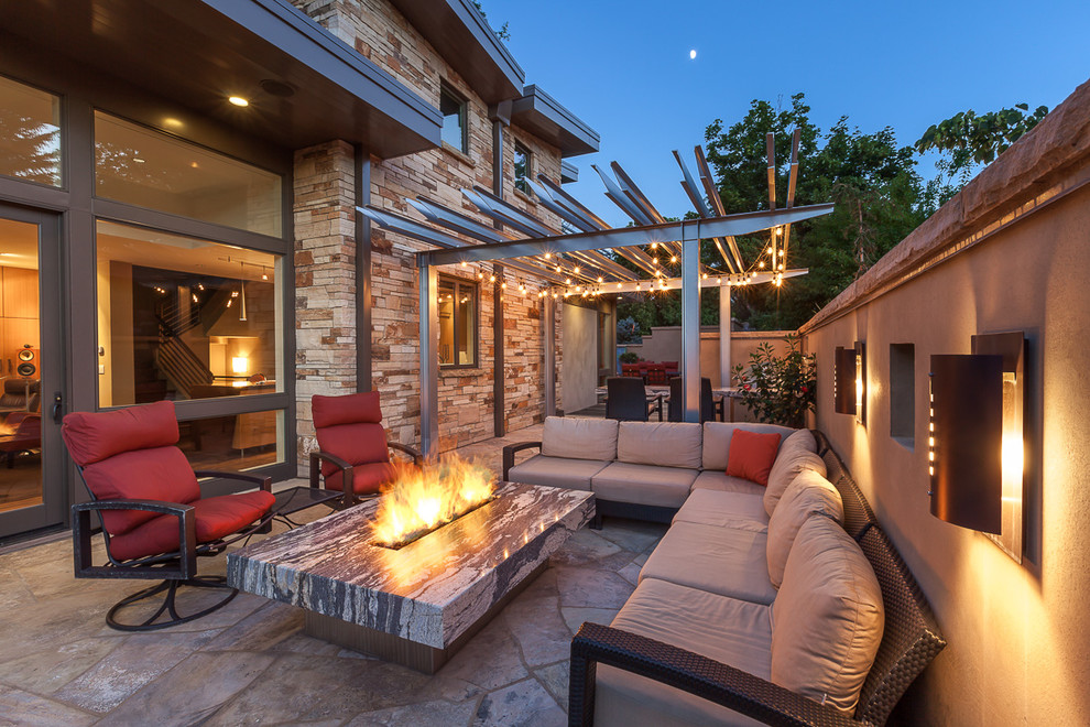Inspiration for a mid-sized contemporary side yard patio in Denver with an outdoor kitchen, natural stone pavers and a gazebo/cabana.