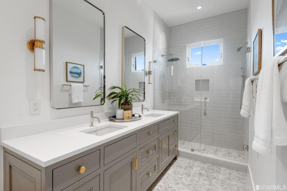 Transitional master bathroom in San Francisco with raised-panel cabinets, grey cabinets, an alcove shower, white tile, ceramic tile, white walls, marble floors, an undermount sink, engineered quartz benchtops, white floor, a hinged shower door, white benchtops, a niche, a double vanity and a freestanding vanity.