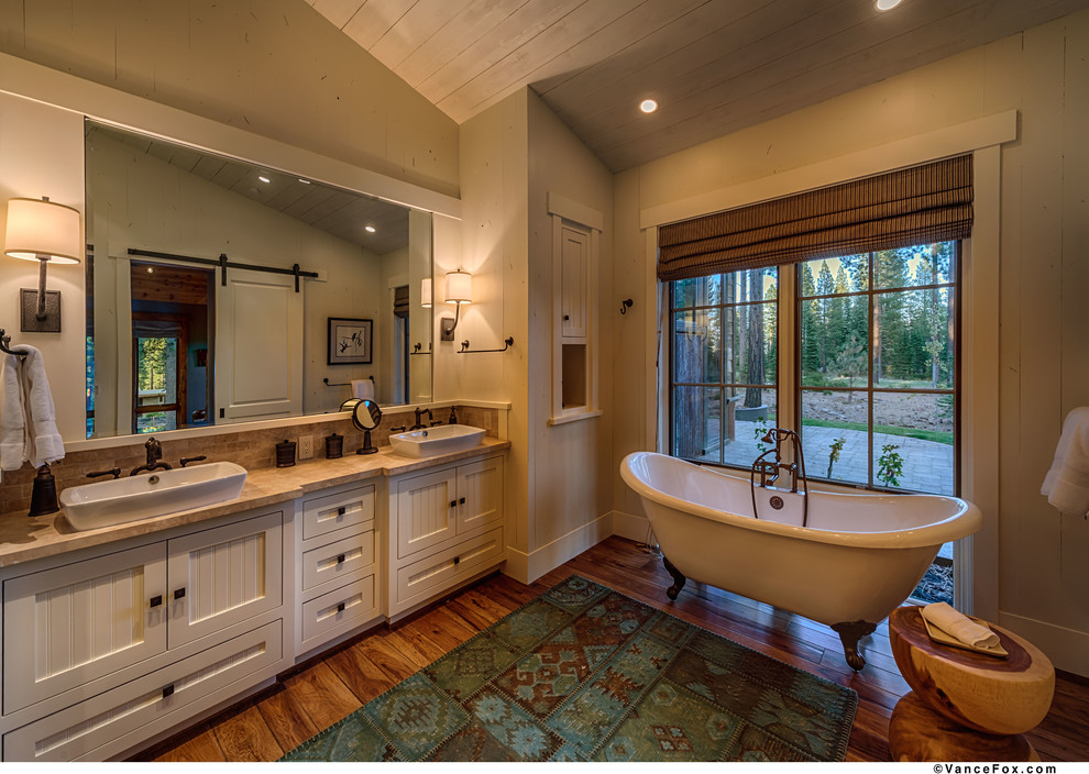 Inspiration for a country bathroom in San Francisco with a claw-foot tub and white cabinets.