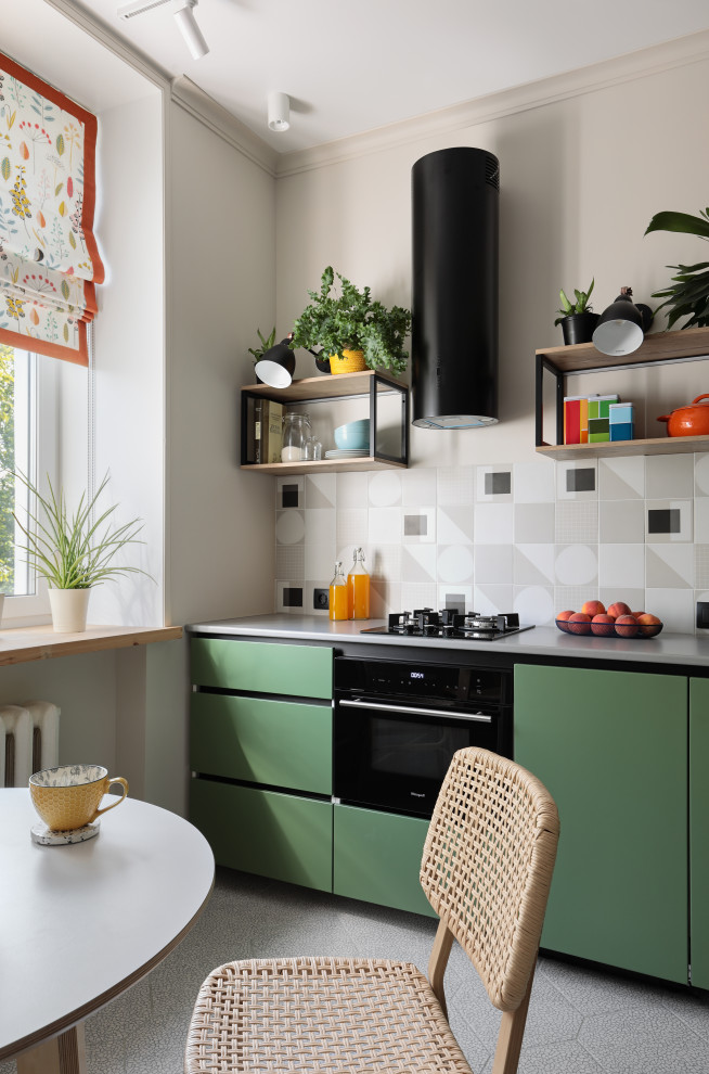 Inspiration for a small scandinavian l-shaped eat-in kitchen in Saint Petersburg with an undermount sink, flat-panel cabinets, green cabinets, solid surface benchtops, grey splashback, ceramic splashback, black appliances, ceramic floors, grey floor and grey benchtop.