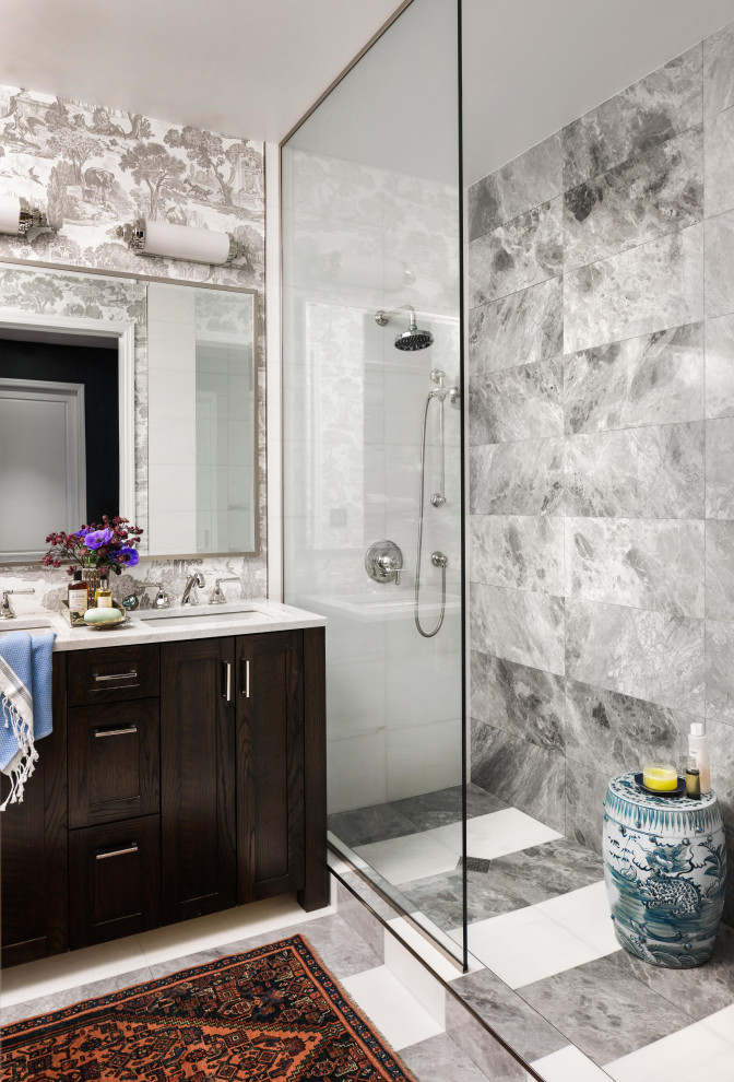 This is an example of a transitional bathroom in Boston with shaker cabinets, dark wood cabinets, an alcove shower, gray tile, an undermount sink, an open shower, white benchtops, a double vanity, wallpaper and a freestanding vanity.
